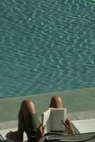 reading a book by the pool