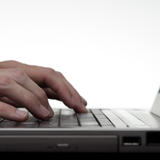 Hands Typing On Laptop Keyboard