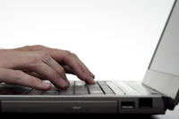 Hands Typing On Laptop Keyboard