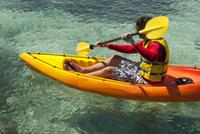 Kayaker paddling in clear water