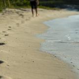 Man walking on a beach with footprints