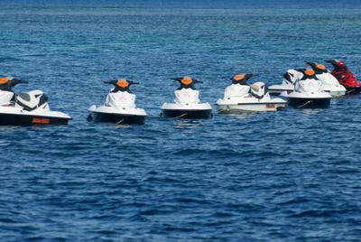 Jet skis moored in a line