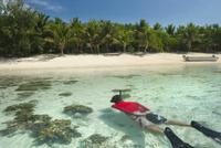 Man snorkeling off a tropical island