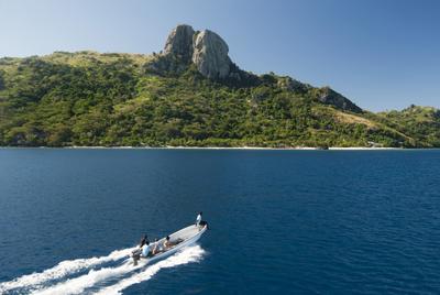 Boat with tourists approaching Waya island