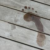 Wet footprint on wooden board
