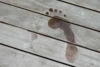 Wet footprint on wooden board