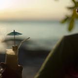 Man with cocktail at sunset