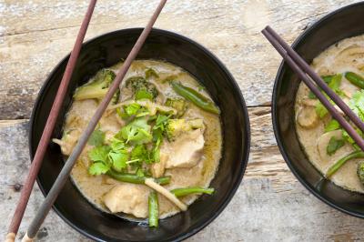 Bowls of Thai green curry with chopsticks