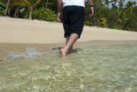 Man paddling in shallow surf