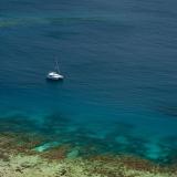 Catamaran moored off a reef
