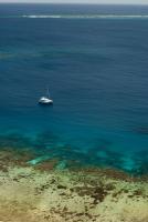 Catamaran moored off a reef