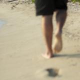Lone man walking on a beach