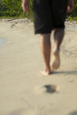 Lone man walking on a beach