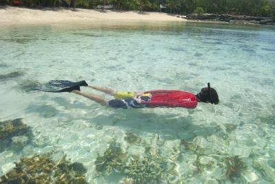 Man snorkeling in cyan waters
