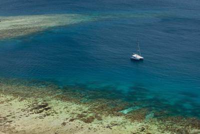 Catamaran moored off a shallow reef