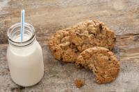 Bottle of milk with half eaten cookies