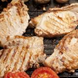 Grilled pork chops and tomatoes on a griddle