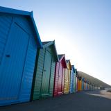 Row of colorful wooden beach huts in Whitby