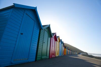 Row of colorful wooden beach huts in Whitby