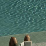 reading a book by the pool