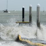 a jetty being smashed by a strom