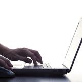 User Typing On Laptop Keyboard