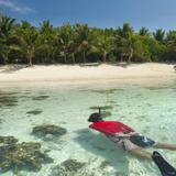 Man snorkeling off a tropical island