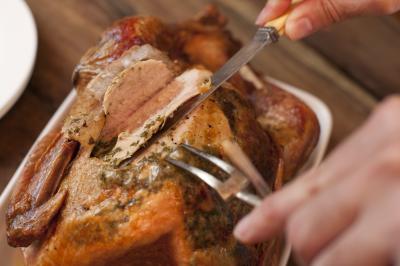 Carving a tasty Thanksgiving roast turkey - Value Stock Photo