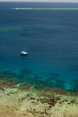 Catamaran moored off a reef