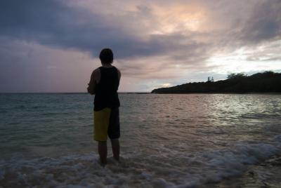 Man watching an ocean sunset