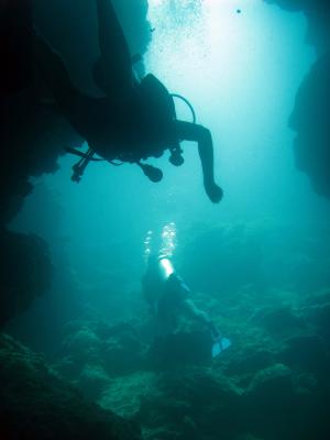 Scuba divers cave diving