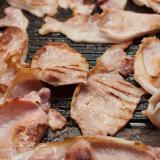 Rashers of smoked bacon on a griddle