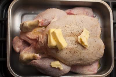 Preparing a raw chicken for roasting